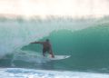 a surfer jumps off a wave into the air